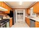Efficient kitchen featuring stainless steel appliances, wood cabinets, and a walk-in pantry at 4424 Robinson St, Acworth, GA 30101