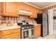 Cozy kitchen featuring stainless steel appliances, ample counter space, and traditional wood cabinetry at 4424 Robinson St, Acworth, GA 30101