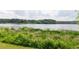 Scenic lake view with lush green vegetation along the shore, creating a tranquil and inviting natural setting at 4424 Robinson St, Acworth, GA 30101