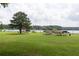 Scenic park by the lake featuring picnic shelters, a large grassy area, and mature trees at 4424 Robinson St, Acworth, GA 30101