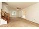Bright living room with a traditional staircase, neutral carpet, and a ceiling fan at 4424 Robinson St, Acworth, GA 30101