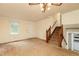 Spacious living room with carpet, a ceiling fan, and staircase leading to the upper level at 4424 Robinson St, Acworth, GA 30101