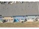 An aerial view highlights the rooftops and backyards of townhomes within a well-maintained residential community at 265 Valley Xing, Canton, GA 30114