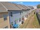 Backyard view of townhomes including a patio, blue outdoor furniture and a small grassy area at 265 Valley Xing, Canton, GA 30114