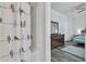 Bathroom featuring a shower and view into bedroom with hardwood floors at 265 Valley Xing, Canton, GA 30114