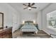 Cozy bedroom showcasing a ceiling fan, hardwood floors, and ample natural light at 265 Valley Xing, Canton, GA 30114