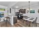 Open kitchen and dining area with dark wood cabinets and stainless steel appliances at 265 Valley Xing, Canton, GA 30114