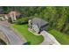 Aerial of gray brick two-story home with large manicured lawn, mature landscaping, and a winding driveway at 3206 Letha Woods Dr, Conyers, GA 30094