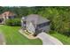 An aerial view of the two-story gray brick home with attached garage and manicured grounds at 3206 Letha Woods Dr, Conyers, GA 30094