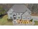 Beautiful grey brick home with a well-manicured lawn and mature trees at 3206 Letha Woods Dr, Conyers, GA 30094