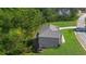 An aerial shot showcasing the house's exterior, a large yard, and its position near the surrounding trees at 3206 Letha Woods Dr, Conyers, GA 30094