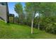 Expansive backyard featuring a lush lawn and mature trees, offering privacy and a connection with nature at 3206 Letha Woods Dr, Conyers, GA 30094