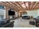 Unfinished basement with exposed framing, windows and concrete floors for customization at 3206 Letha Woods Dr, Conyers, GA 30094