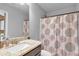 Bathroom featuring vanity with storage, mirror and shower with patterned curtain at 3206 Letha Woods Dr, Conyers, GA 30094