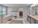 A primary bathroom features a soaking tub, tiled floors, and granite counters at 3206 Letha Woods Dr, Conyers, GA 30094