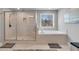 Bathroom featuring a glass enclosed shower, soaking tub, and natural light at 3206 Letha Woods Dr, Conyers, GA 30094