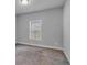 Neutral bedroom featuring a window and neutral carpet at 3206 Letha Woods Dr, Conyers, GA 30094