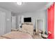 Bedroom featuring a bed, dresser, mirror, mounted TV and window at 3206 Letha Woods Dr, Conyers, GA 30094