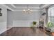 Spacious dining room featuring hardwood floors, a chandelier, and decorative molding, ready for your personal touch at 3206 Letha Woods Dr, Conyers, GA 30094