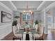 Elegant dining room with decorative chandelier, tray ceiling, and stylish furnishings for sophisticated entertaining at 3206 Letha Woods Dr, Conyers, GA 30094