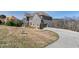 A gray brick two-story home with an attached two-car garage and a long, paved driveway at 3206 Letha Woods Dr, Conyers, GA 30094