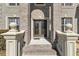 The double front doors of this gray brick two-story home are surrounded by detailed molding and landscaping at 3206 Letha Woods Dr, Conyers, GA 30094