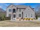 Charming grey brick home with manicured lawn and professional landscaping with mature trees at 3206 Letha Woods Dr, Conyers, GA 30094