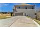 The two-car attached garage and extended driveway of this gray brick two-story home at 3206 Letha Woods Dr, Conyers, GA 30094