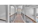 Upstairs hallway featuring wood railing and arches that separate living spaces at 3206 Letha Woods Dr, Conyers, GA 30094