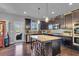 Well-appointed kitchen featuring dark wood cabinets, granite countertops and stainless steel appliances at 3206 Letha Woods Dr, Conyers, GA 30094