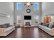 Open living room with a fireplace, large windows, and hardwood floors at 3206 Letha Woods Dr, Conyers, GA 30094