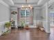 Bright living room with hardwood floors, plants and stylish chandelier, perfect for entertaining guests at 3206 Letha Woods Dr, Conyers, GA 30094