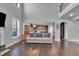 Inviting living room featuring hardwood floors, a cozy sofa, and a seamless transition into the kitchen at 3206 Letha Woods Dr, Conyers, GA 30094