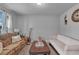 Cozy living room featuring neutral colors, a comfortable sofa, and natural light from the window at 3206 Letha Woods Dr, Conyers, GA 30094