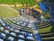 Aerial view of an outdoor amphitheater with concert stage and sloped lawn seating at 420 Eagle Tiff Dr, Sugar Hill, GA 30518