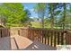 Lovely deck featuring wood railings with a beautiful view of a golf course and mature trees at 420 Eagle Tiff Dr, Sugar Hill, GA 30518