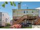Exterior backyard view of multi-level deck surrounded by lush landscaping at 420 Eagle Tiff Dr, Sugar Hill, GA 30518