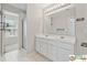 This bathroom features dual sinks, a large mirror, and access to a walk-in shower at 420 Eagle Tiff Dr, Sugar Hill, GA 30518