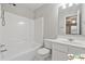 This bright bathroom features a shower/tub combo with modern fixtures and a large vanity at 420 Eagle Tiff Dr, Sugar Hill, GA 30518