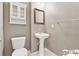 Cozy bathroom features a pedestal sink, neutral colors and a decorative mirror at 420 Eagle Tiff Dr, Sugar Hill, GA 30518