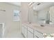 This bright bathroom features dual sinks, a large mirror, and natural light at 420 Eagle Tiff Dr, Sugar Hill, GA 30518