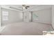 Spacious carpeted bedroom features a tray ceiling, ceiling fan, and multiple windows for ample light at 420 Eagle Tiff Dr, Sugar Hill, GA 30518