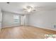 Bright, airy bedroom with hardwood floors, a ceiling fan, and neutral walls, creating a cozy atmosphere at 420 Eagle Tiff Dr, Sugar Hill, GA 30518