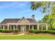 Charming clubhouse featuring brick accents, manicured landscaping and a covered porch at 420 Eagle Tiff Dr, Sugar Hill, GA 30518