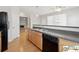 Kitchen featuring stainless steel appliances, hardwood floors, and a view of the living room at 420 Eagle Tiff Dr, Sugar Hill, GA 30518
