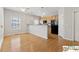 Open concept kitchen featuring hardwood floors, breakfast bar, and stainless steel appliances at 420 Eagle Tiff Dr, Sugar Hill, GA 30518