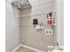 The laundry room is fitted with multiple wire shelves and laundry connections at 420 Eagle Tiff Dr, Sugar Hill, GA 30518