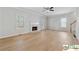 Bright living room featuring hardwood floors, fireplace, a ceiling fan and lots of natural light at 420 Eagle Tiff Dr, Sugar Hill, GA 30518