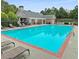 Community pool surrounded by lounge chairs and a well-kept pool deck at 420 Eagle Tiff Dr, Sugar Hill, GA 30518