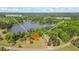Aerial view of lake, greenhouse, and fruit trees, highlighting the property's natural features at 50 Silver Lake Dr, Mansfield, GA 30055